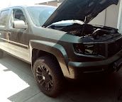 Dark Honda Ridgeline pickup with the hood up