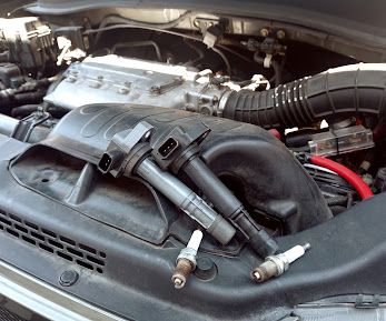 Old spark plugs and ignition coils pulled from an engine